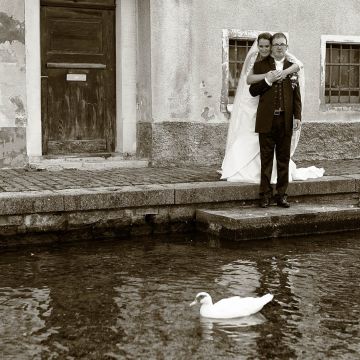 Braut umarmt sich am Seebach in Westhafen mit Enten im Vordergrund